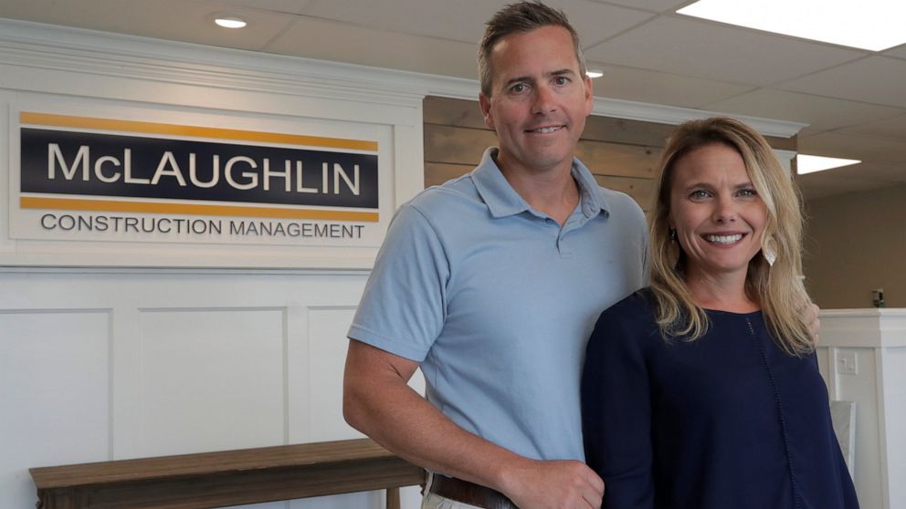 In this Wednesday, June 5, 2019, photo, Chris Carr, left, president of McLaughlin Construction Management, poses for a photo with his wife Kristy Carr in their office in Sea Isle City, N.J. When Kristy's father Jim McLaughlin died suddenly from a hea
