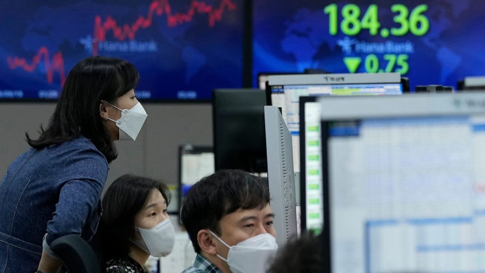 Currency traders watch monitors at the foreign exchange dealing room of the KEB Hana Bank headquarters in Seoul, South Korea, Friday, Oct. 15, 2021. Asian shares were higher Friday after technology companies powered the biggest gain on Wall Street si