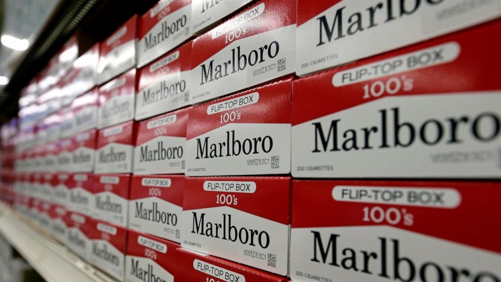 FILE- This June 14, 2018, file photo shows cartons of Marlboro cigarettes on the shelves at JR outlet in Burlington, N.C. Shares of Altria Group, fell Tuesday, July 30, 2019, as the nation’s largest tobacco company predicted steeper declines for ciga