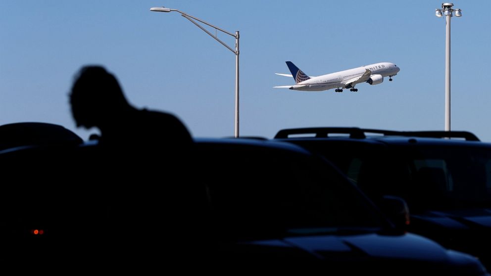 FILE - A passenger is silhouetted as a United Airlines plane takes off at O'Hare International Airport in Chicago on July 1, 2021. United Airlines said Wednesday, July 20, 2022, that it earned $329 million in the second quarter as summer vacationers 