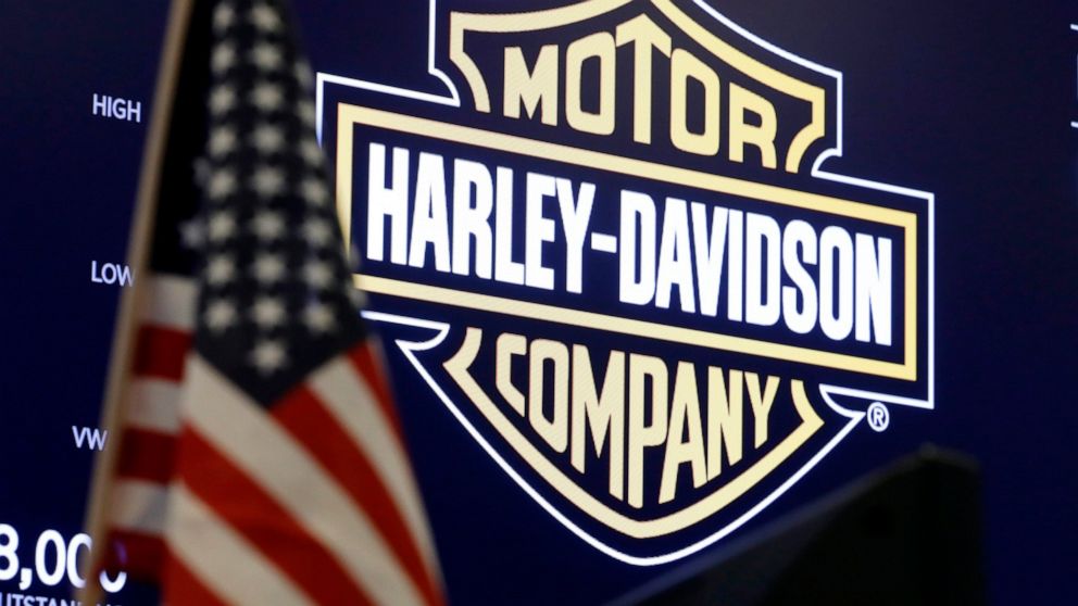 FILE - The logo for Harley-Davidson appears above a trading post on the floor of the New York Stock Exchange, March 3, 2020. Harley-Davidson shares fell more than 7% Thursday, May 19, 2022 after the motorcycle maker said it was suspending vehicle ass