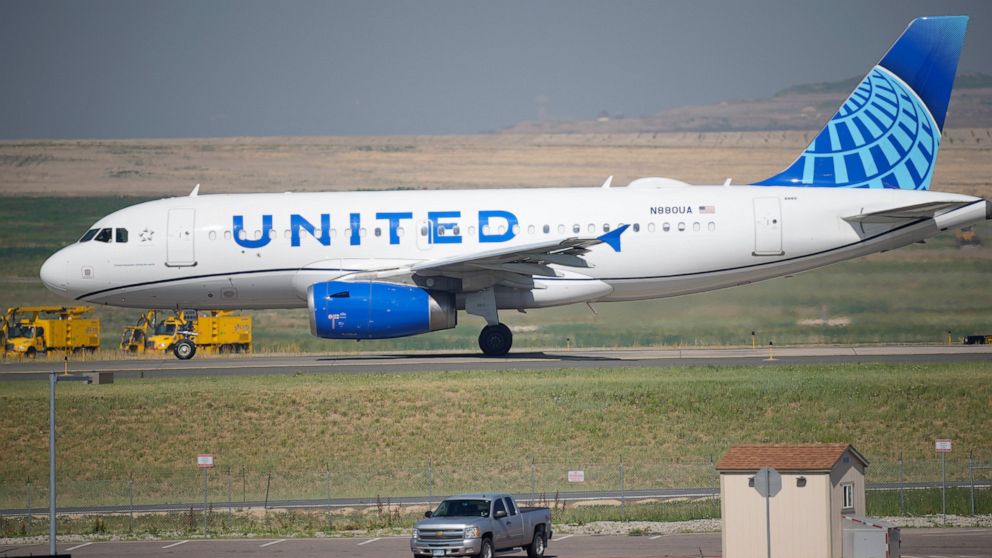 The Latest: United Airlines: Shots required for US workers