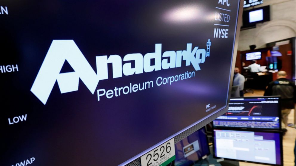 FILE - In this April 12, 2019, file photo the logo for Anadarko Petroleum Corp. appears above a trading post on the floor of the New York Stock Exchange. Warren Buffet’s Berkshire Hathaway is financing a bid by Occidental Petroleum for Anadarko, pote