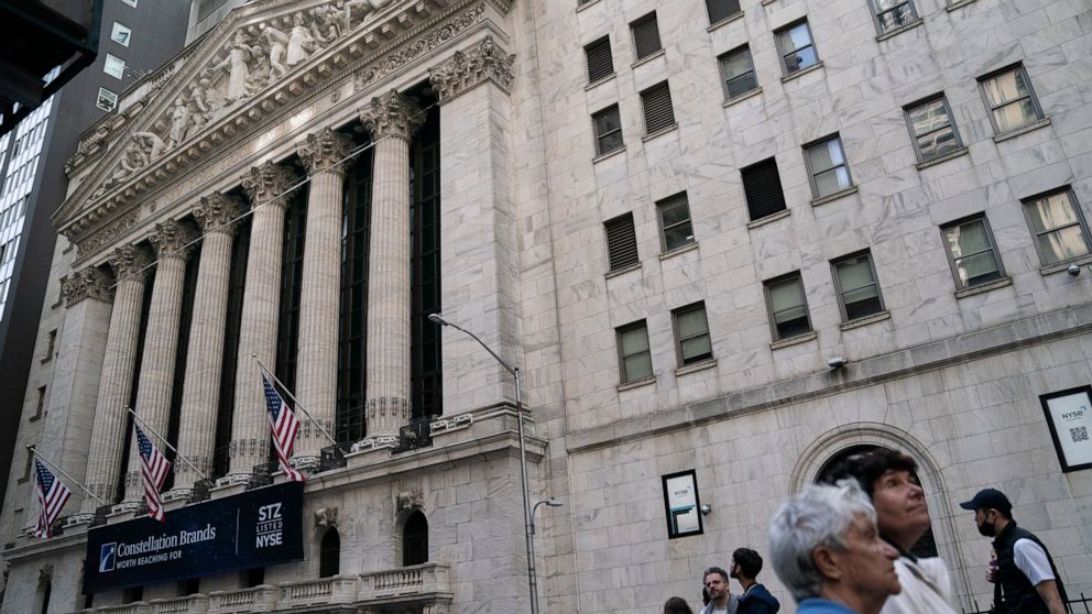 Pedestrians pass the New York Stock Exchange, May 5, 2022, in the Manhattan borough of New York. Stocks are off to a higher start on Wall Street Monday, June 6, 2022 led by more gains in big tech companies. The S&P 500 was up 0.8%. The benchmark inde
