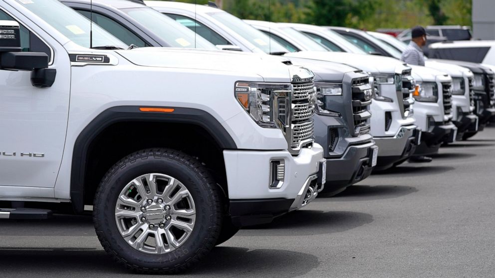 FILE -GMC pick-up trucks are lined up on the sales lot at the Albrecht Auto Group dealership, Tuesday, Aug. 3, 2021, in Wakefield, Mass. U.S. new-vehicle sales were expected to fall around 15% in the first quarter compared with a year ago, as the glo