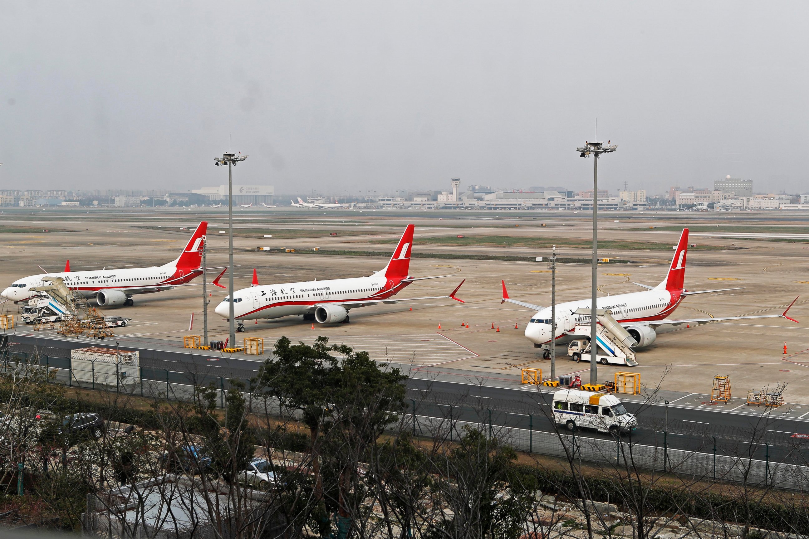 In this photo taken Monday, March 11, 2019, three Shanghai Airlines Boeing 737 Max 8 passenger planes are parked at the Hongqiao Airport in Shanghai, China. U.S. Aviation experts on Tuesday, March 12, 2019 joined the investigation into the crash of a