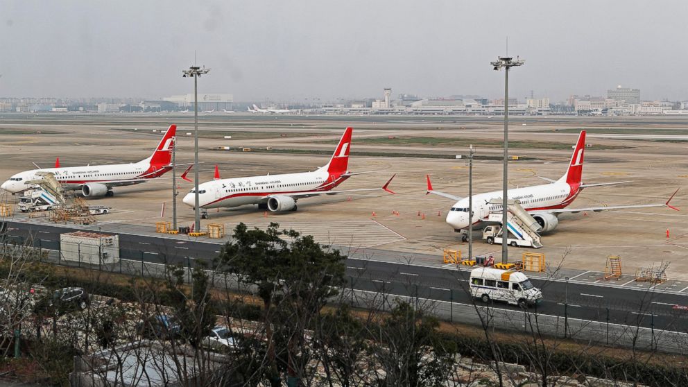 In this photo taken Monday, March 11, 2019, three Shanghai Airlines Boeing 737 Max 8 passenger planes are parked at the Hongqiao Airport in Shanghai, China. U.S. Aviation experts on Tuesday, March 12, 2019 joined the investigation into the crash of a