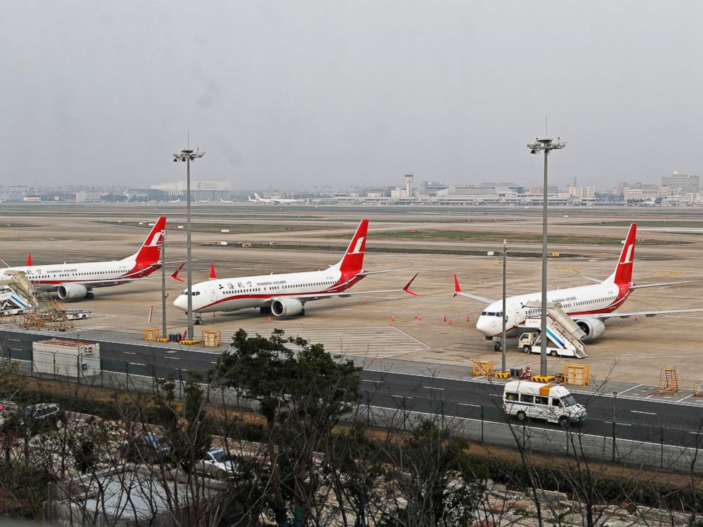 In this photo taken Monday, March 11, 2019, three Shanghai Airlines Boeing 737 Max 8 passenger planes are parked at the Hongqiao Airport in Shanghai, China. U.S. Aviation experts on Tuesday, March 12, 2019 joined the investigation into the crash of a
