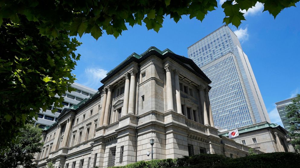 FILE - A Japanese flag flutters at the Bank of Japan headquarters in Tokyo on July 29, 2022. Japan’s central bank took the unusual step Thursday, Sept. 22, of intervening in the market to stem the yen’s decline against the U.S. dollar. (AP Photo/Shuj