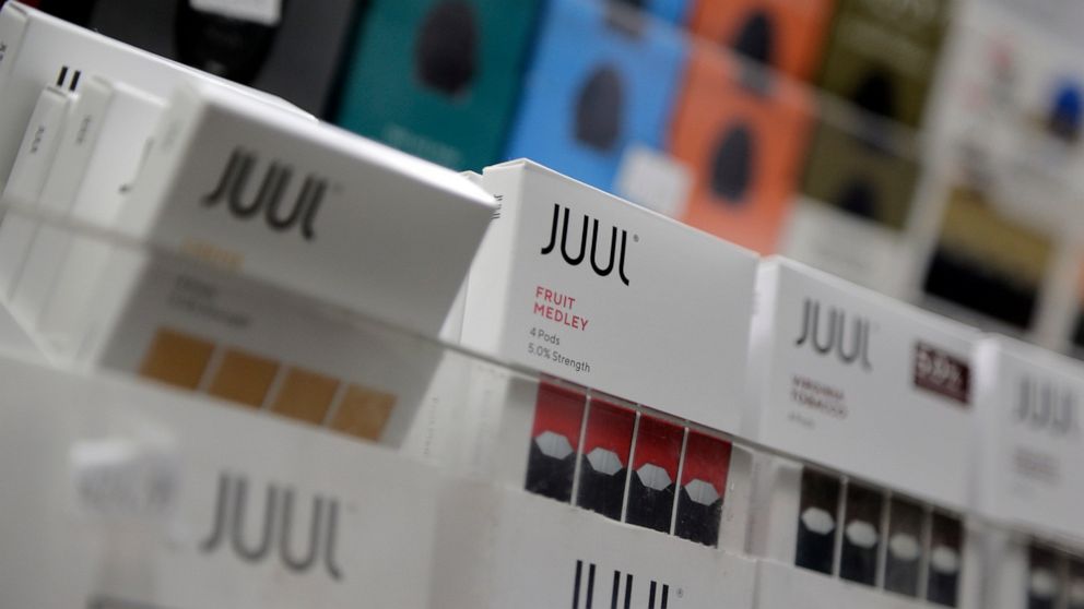 FILE - Juul products are displayed at a smoke shop in New York, on Dec. 20, 2018. Embattled vaping company Juul Labs announced layoffs Thursday, Nov. 10, 2022, as the company tries to weather growing setbacks to its electronic cigarette business, inc