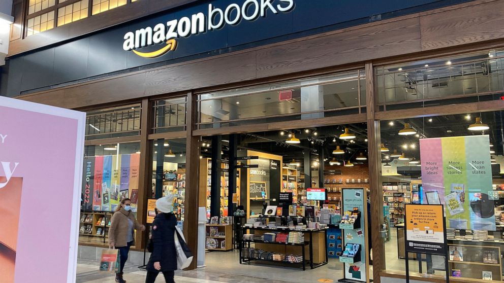 FILE - People walk by an Amazon Books store at the Westfield Garden State Plaza shopping mall in Paramus, N.J., Monday, Jan. 10, 2022. Amazon confirmed on Wednesday, March 2, 2022, that it’s closing all of its physical bookstores as well as its 4-sta