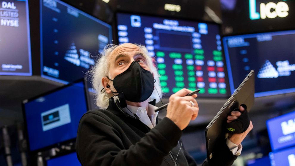 In this photo provided by the New York Stock Exchange, trader Peter Tuchman works on the floor, Wednesday, Feb. 9, 2022. Stocks rose broadly in afternoon trading on Wall Street Wednesday, putting the market further into the green for the week after a