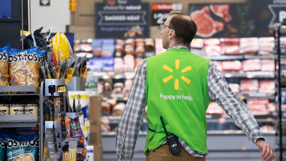 FILE - In this April 24, 2019, file photo a Walmart associate works at a Walmart Neighborhood Market in Levittown, N.Y. Walmart Inc. reports financial results Thursday, Aug. 15. (AP Photo/Mark Lennihan, File)