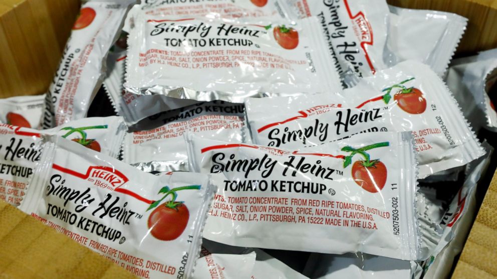 Packets of Simply Heinz ketchup fill a cafeteria condiment box, Thursday, Aug. 8, 2019. Kraft Heinz Co. on Thursday reported second-quarter net income of $449 million. (AP Photo/Richard Drew)