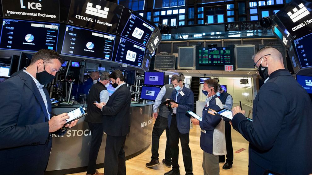 In this photo provided by the New York Stock Exchange, traders work on the floor, Friday, May 7, 2021. Stocks are rallying to records on Wall Street Friday despite a stunningly disappointing report on the nation's job market, as investors see it help