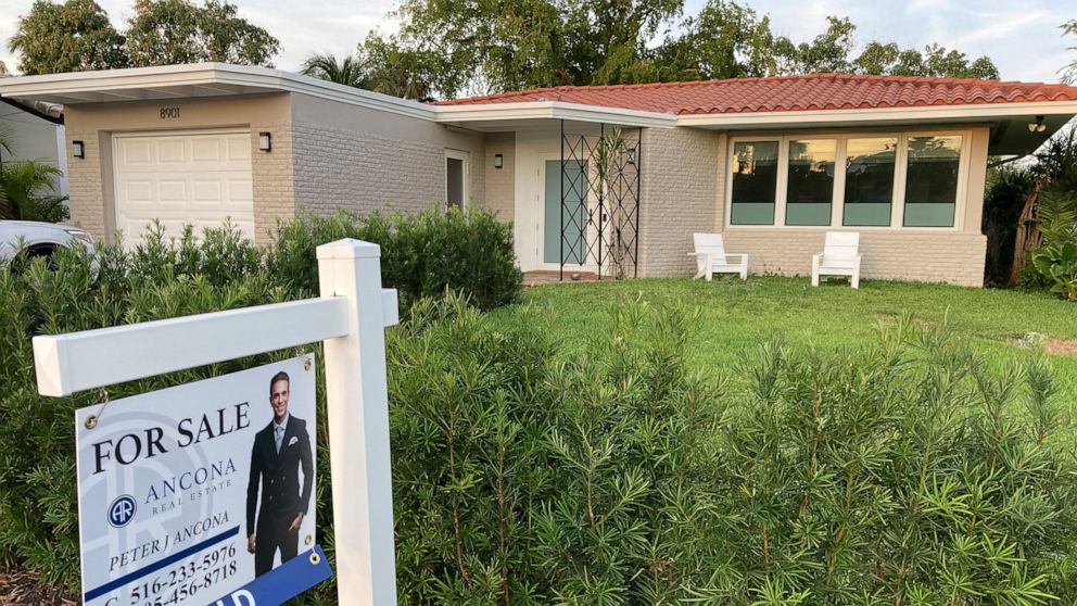FILE - A home with a "Sold" sign is shown, Sunday, May 2, 2021, in Surfside, Fla. Average long-term U.S. mortgage rates inched up this week following last week’s mammoth jump, the biggest in 35 years. Mortgage buyer Freddie Mac reported Thursday, Jun