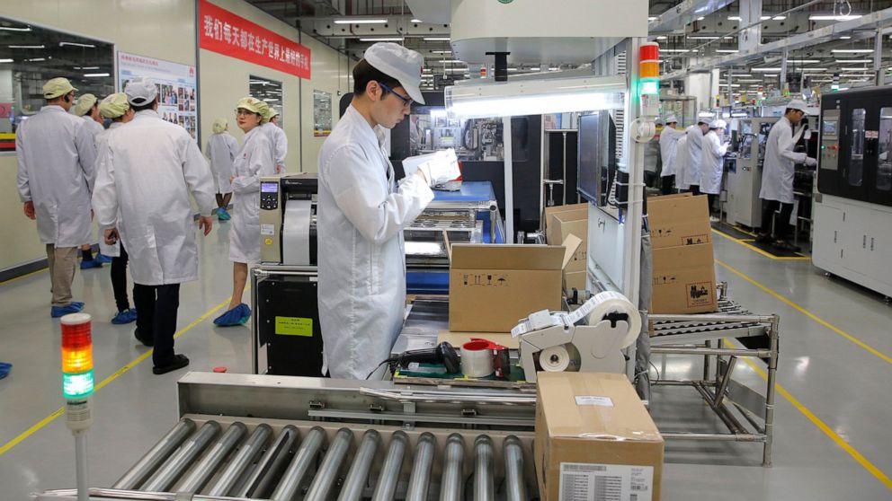 FILE - In this March 6, 2019, file photo a staff member works on a mobile phone production line during a media tour in Huawei factory in Dongguan, China's Guangdong province. Huawei Technologies Co. is one of the world's biggest supplier of telecommu