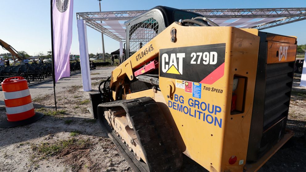 In this May 8, 2019 photo, a Caterpillar 279D Compact Track Loader sits at a demolition site in Fort Lauderdale, Fla. Caterpillar Inc. reports earning on Wednesday, July 24, 2019. (AP Photo/Wilfredo Lee)