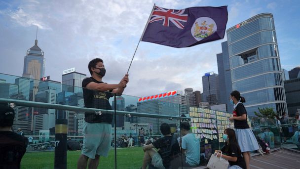 FILE - A protester waves Hong Kong British colony flag during continuing pro-democracy rallies in Tamar Park, Hong Kong, on Sept. 3, 2019. When the British handed its colony Hong Kong to Beijing in 1997, it was promised 50 years of self-government and freedoms of assembly, speech and press that are not allowed Chinese on the Communist-ruled mainland. As the city of 7.4 million people marks 25 years under Beijing's rule on Friday, those promises are wearing thin. Hong Kong's honeymoon period, when it carried on much as it always had, has passed, and its future remains uncertain, determined by forces beyond its control. (AP Photo/Vincent Yu, File)