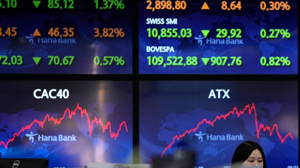 An employee of a bank walks by the screens at a foreign exchange dealing room in Seoul, South Korea, Thursday, Sept. 1, 2022. Asian shares were mostly lower Thursday, tracking the broad slide on Wall Street, as investors braced for higher interest ra