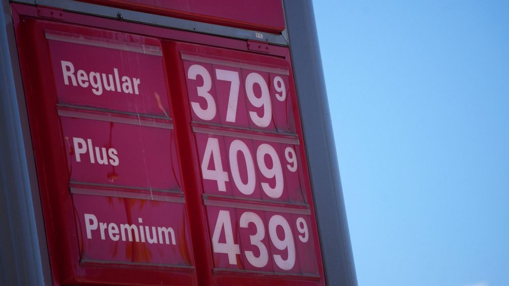 FILE - In this Oct. 24 2021, file photo, gas pump prices are posted on a sign at a Conoco station in southeast Denver. Americans’ opinions on the U.S. economy have soured noticeably in the past month, a new poll finds, as the cost of goods is rising 