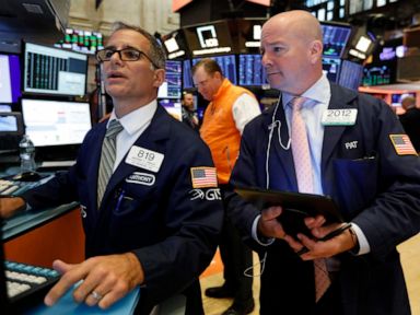 Stocks climb as job report gives some solace after wild week