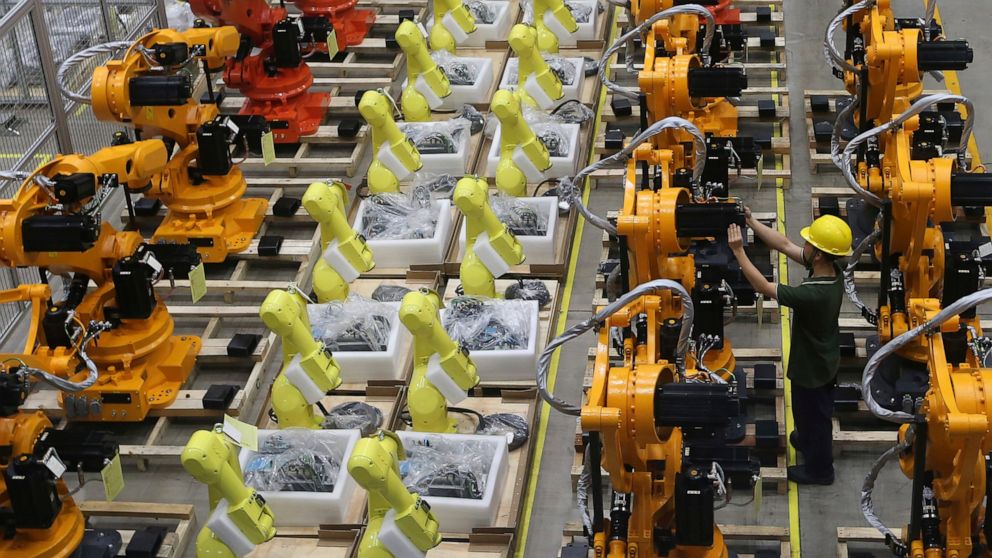 A worker checks on robot arms at a factory in Nanjing in east China's Jiangsu province, Thursday, June 6, 2019. China's Commerce Ministry will release a list of "unreliable" foreign companies in the near future, a spokesman said Thursday, without giv