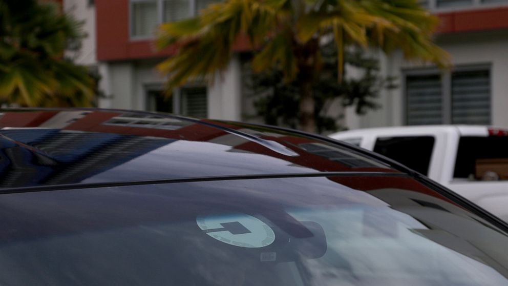 FILE- In this June 6, 2018, file photo Uber driver Joshua Oh drives in Honolulu. Uber launched a voucher program Tuesday, April 9, 2019, enabling companies like Westfield Mall and TGI Fridays to offer free or discounted Uber rides to customers. (AP P