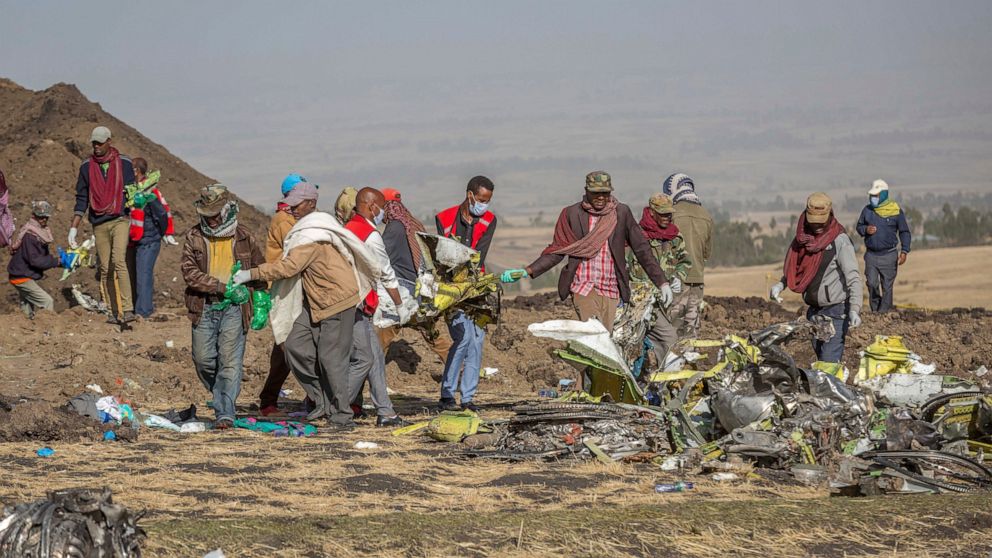 FILE - Rescuers work at the scene of an Ethiopian Airlines flight crash near Bishoftu, or Debre Zeit, south of Addis Ababa, Ethiopia, Monday, March 11, 2019. Relatives of passengers who died in crashes of Boeing 737 Max jets are pressing Attorney Gen