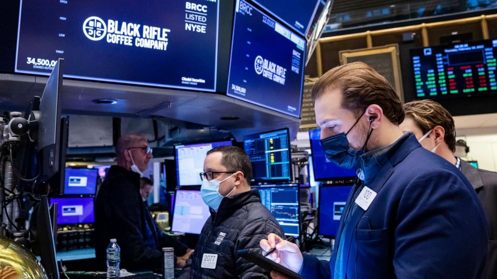 In this photo provided by the New York Stock Exchange, traders work on the floor, Thursday, Feb 10, 2022. With inflation going only higher, stocks edged lower on Wall Street Thursday as expectations build that the Federal Reserve will have to get mor