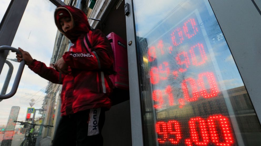 Ruble plummets as sanctions bite, sending Russians to banks