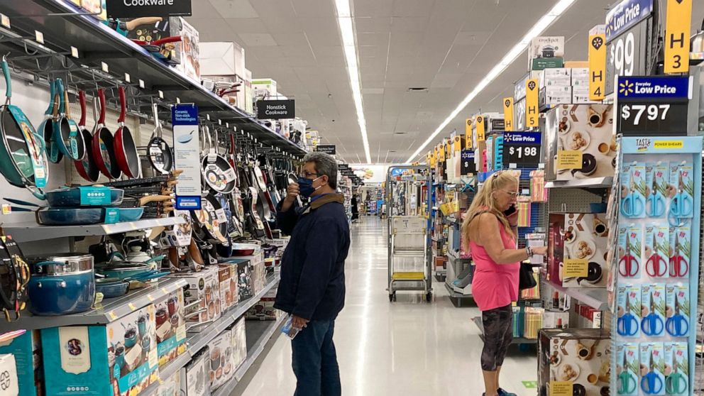 Consumers shop as they wear a mask at a Walmart store in Vernon Hills, Ill., Sunday, May 23, 2021. U.S. consumer confidence rose for a fifth month in June to the highest level since the pandemic began last year as households responded to increased va