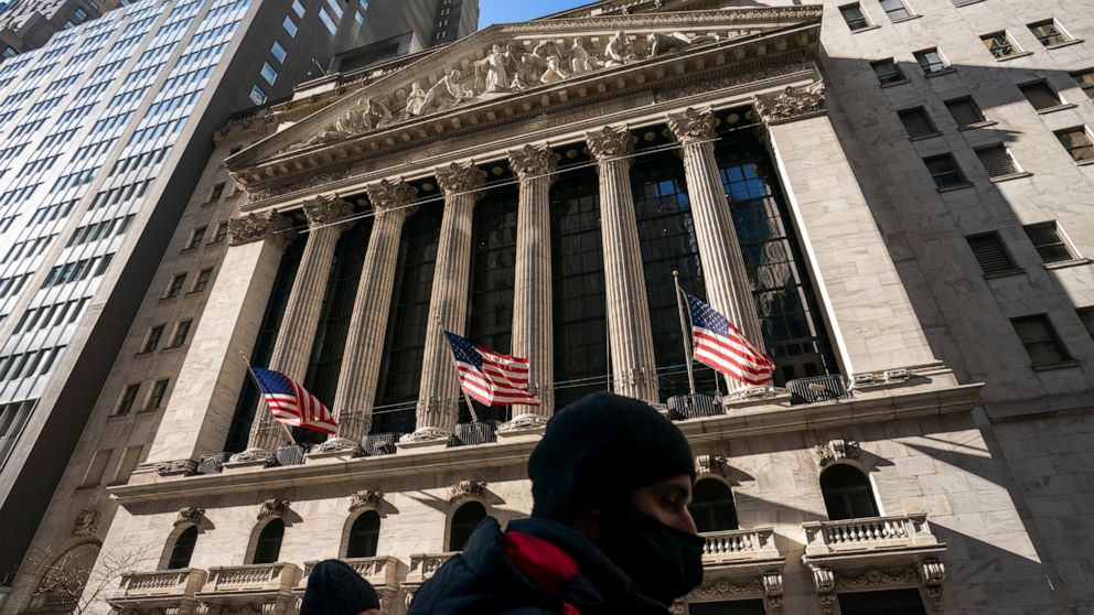 FILE - A pedestrian passes the New York Stock Exchange, Monday, Jan. 24, 2022, in New York. The stock market is losing crucial support from the Federal Reserve. Omicron is causing havoc at businesses around the world. And Russia just might be prepari