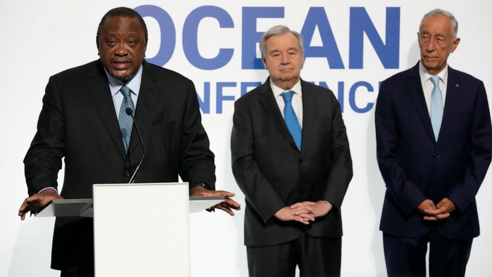 Kenya President Uhuru Kenyatta, left, addresses journalists during a joint news conference with United Nations Secretary-General Antonio Guterres and Portuguese President Marcelo Rebelo de Sousa, right, at the UN Ocean Conference in Lisbon, Monday, J