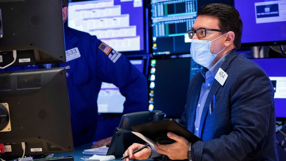 In this photo provided by the New York Stock Exchange, trader Americo Brunetti works on the floor, Thursday, Jan. 27, 2022. Stocks gave up early gains and turned mixed in afternoon trading on Wall Street Thursday as markets struggle to settle down fo