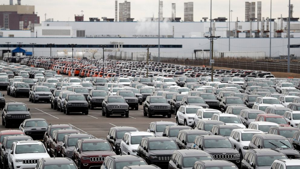 FILE - In this Feb. 26, 2019, file photo, Jeep vehicles are parked outside the Jefferson North Assembly Plant in Detroit. Fiat Chrysler is backing off a planned May 4 restart at its North American factories because some U.S. states still will have st