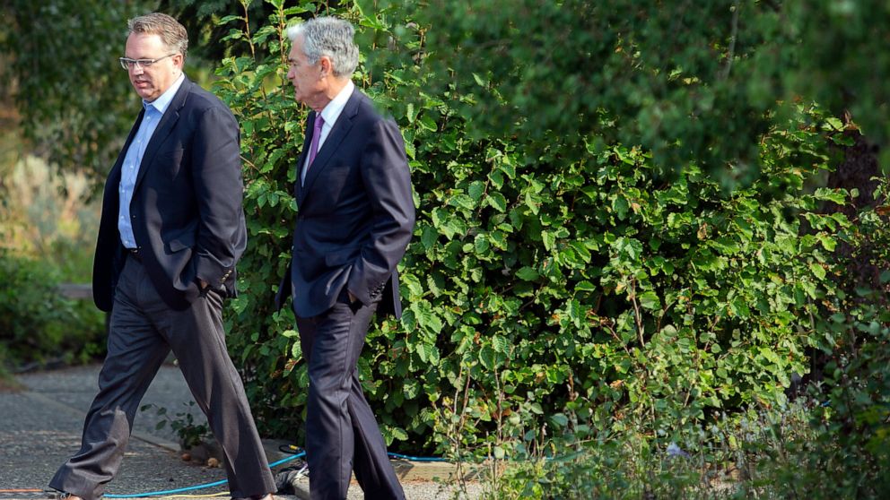 FILE - In this Aug. 24, 2018, file photo John Williams, left, President and CEO of the Federal Reserve Bank of New York, and Jerome Powell, Chairman of the Board of Governors of the Federal Reserve System walk together after Powell's speech at the Ja