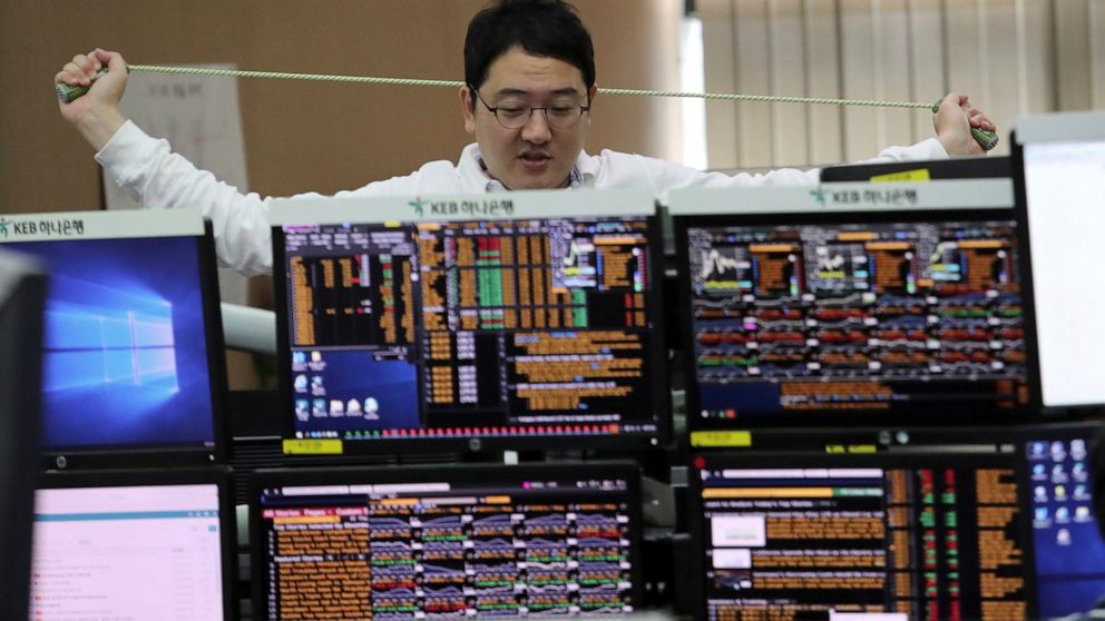A currency trader stretches at the foreign exchange dealing room of the KEB Hana Bank headquarters in Seoul, South Korea, Friday, Sept. 27, 2019. Asian stocks were mixed Friday as traders weighed data showing slower U.S. economic growth and the possi
