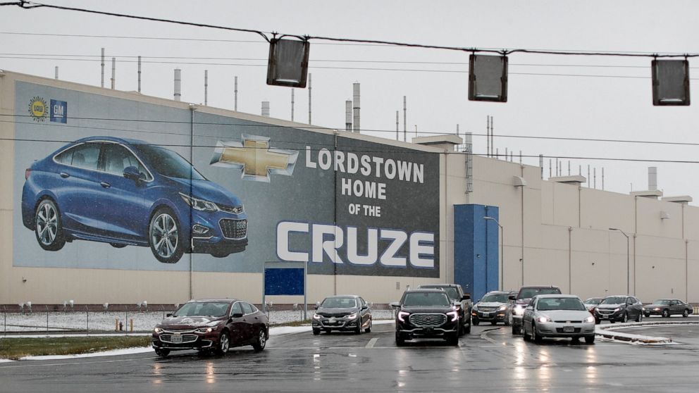 FILE - In this Nov. 27, 2018, file photo a banner depicting the Chevrolet Cruze model vehicle is displayed at the General Motors' Lordstown plant in Lordstown, Ohio. An economic renaissance in the industrial Midwest promised by President Donald Trump