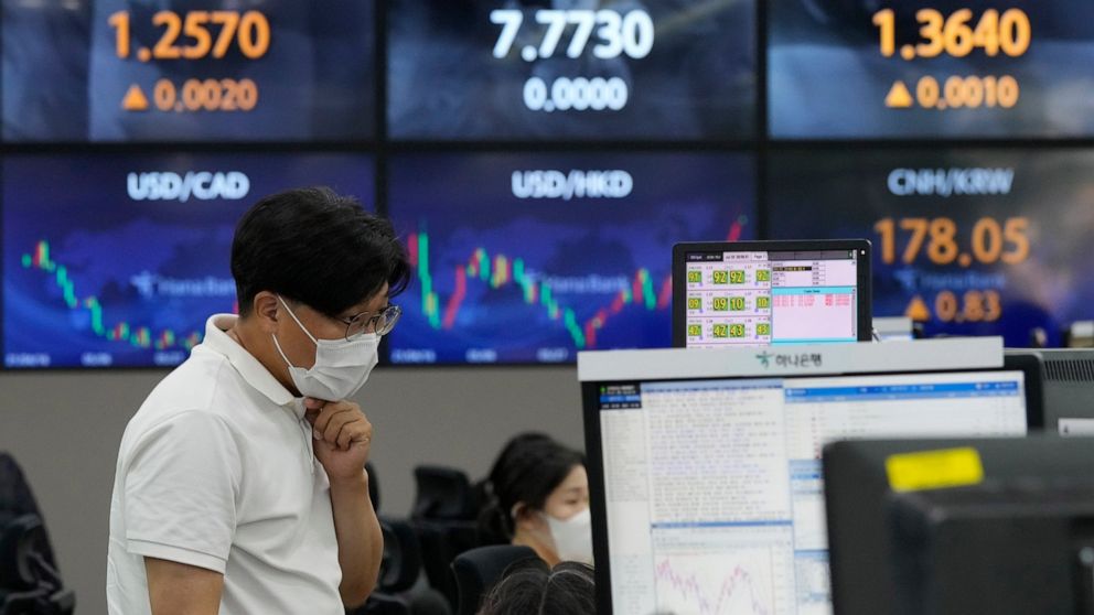 A currency trader watches monitors at the foreign exchange dealing room of the KEB Hana Bank headquarters in Seoul, South Korea, Thursday, July 22, 2021. Asian stock markets followed Wall Street higher Thursday for a second day as optimism about an e