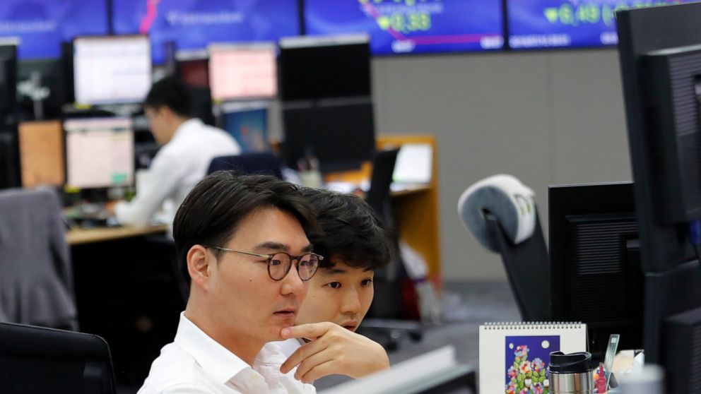 Currency traders watch monitors at the foreign exchange dealing room of the KEB Hana Bank headquarters in Seoul, South Korea, Monday, July 15, 2019. Shares are mixed in Asia, led by gains in Chinese markets after the government reported that the econ