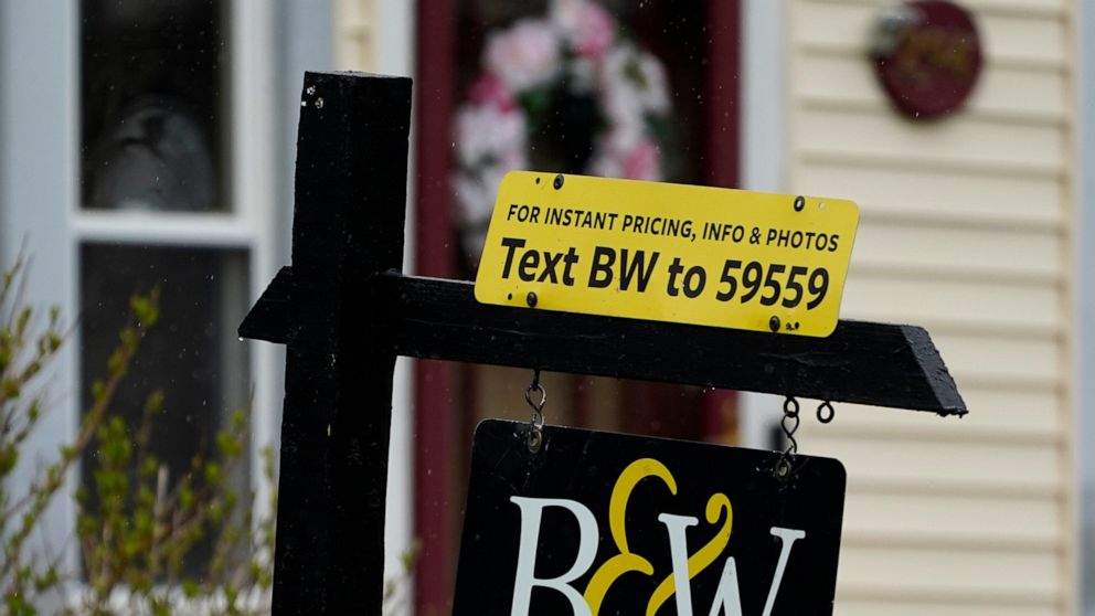 A sign is displayed outside a home in Wheeling, Ill., Thursday, May 5, 2022. Average long-term U.S. mortgage rates made their biggest one-week jump in 35 years, one day after the Federal Reserve raised its key rate by three-quarters of a point in bid