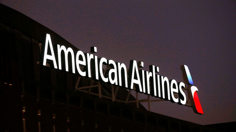 FILE - The American Airlines logo on top of the American Airlines Center in Dallas, Texas on Dec. 19, 2017. Passengers and crew members restrained a passenger who was caught on video slugging a flight attendant on an American Airlines plane. The airl