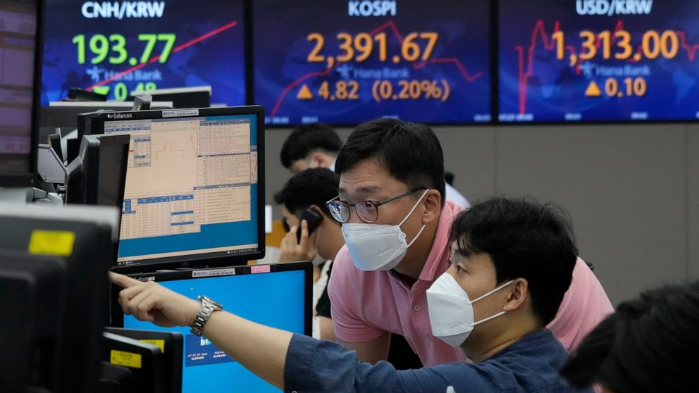 Currency traders watch monitors at the foreign exchange dealing room of the KEB Hana Bank headquarters in Seoul, South Korea, Thursday, July 21, 2022. Asian shares mostly slipped Thursday, as optimism was tempered by persistent concerns about inflati