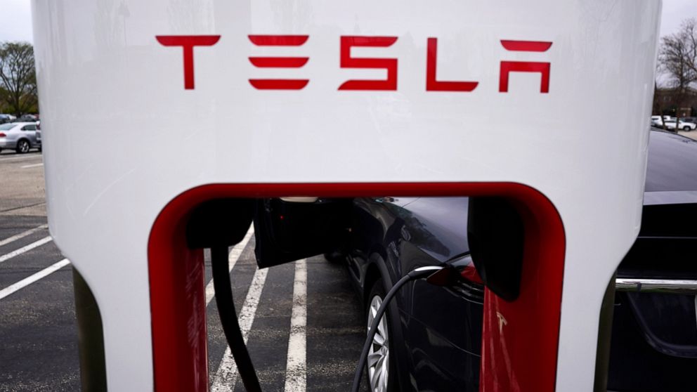 FILE - Tesla Supercharger is seen at Willow Festival shopping plaza parking lot in Northbrook, Ill., on May 5, 2022. Tesla shareholders on Thursday, Aug. 4, 2022 approved a three-for-one stock split, a move that will make the company's shares more ac