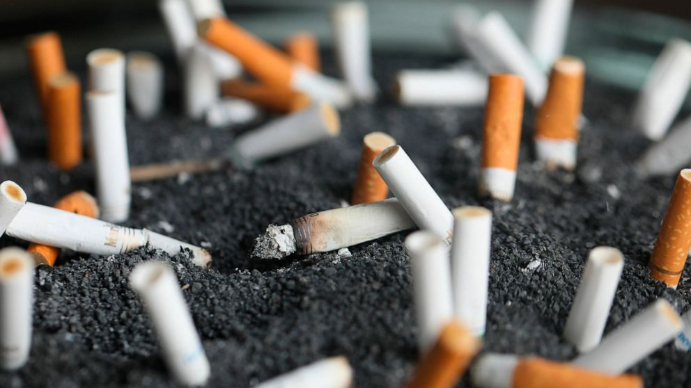 FILE - This March 28, 2019, file photo shows cigarette butts in an ashtray in New York. Two of the hottest trends in investing are working in tandem to steer billions of dollars toward companies seen as the best corporate citizens. The sustainable in