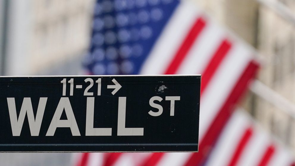 FILE - A Wall Street sign hangs in front of the New York Stock Exchange in New York, on June 14, 2022. Stocks are opening higher on Wall Street Wednesday, Aug. 3. (AP Photo/Seth Wenig, File)