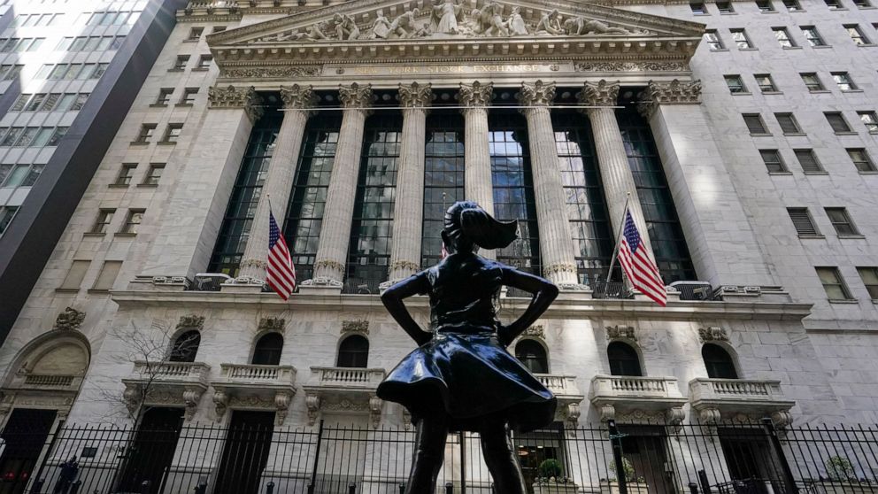 FILE - In this March 23, 2021 file photo, the Fearless Girl statue stands in front of the New York Stock Exchange in New York's Financial District. Stocks are opening modestly higher on Wall Street at the beginning of another heavy week for earnings 