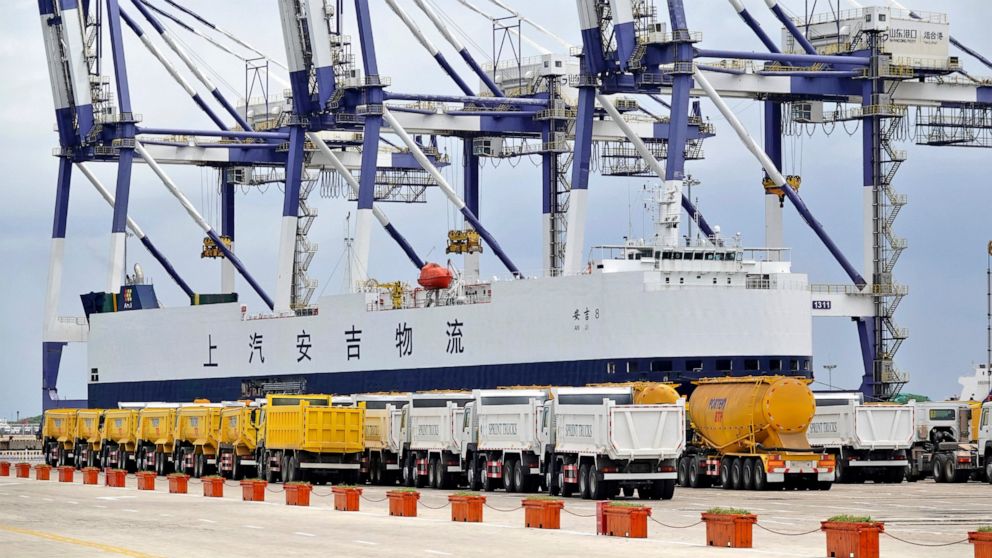 Trucks manufactured for export are lined up at a cargo port in Yantai in eastern China's Shandong Province, Friday, July 30, 2021. China's trade rose by double digits in July but growth slowed as global efforts to control the coronavirus's more conta