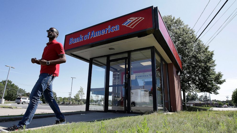 In this Monday, July 15, 2019 photo a customer departs a Bank of America ATM, in Norwood, Mass. Bank of America Corp. reports earnings Wednesday, July 17. (AP Photo/Steven Senne)